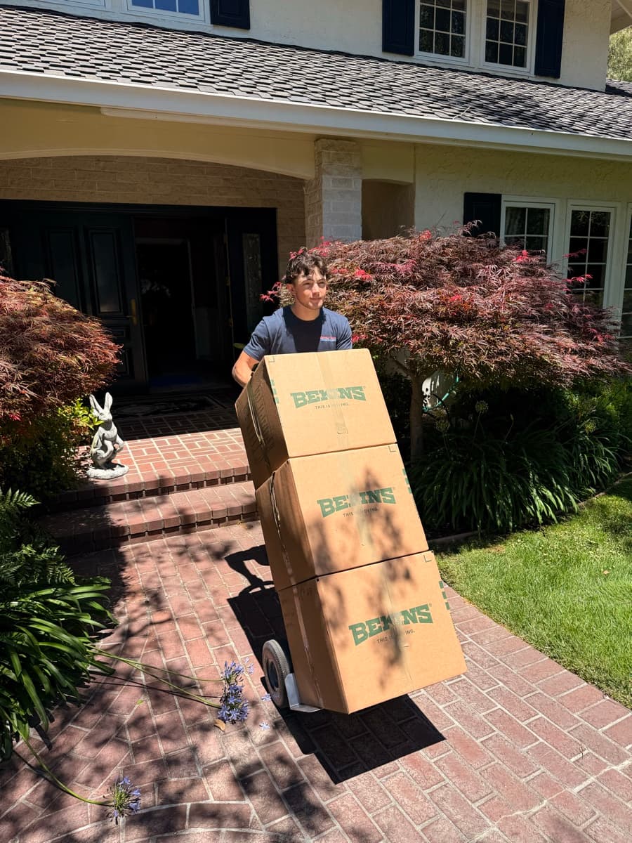 Professional mover carrying moving boxes
