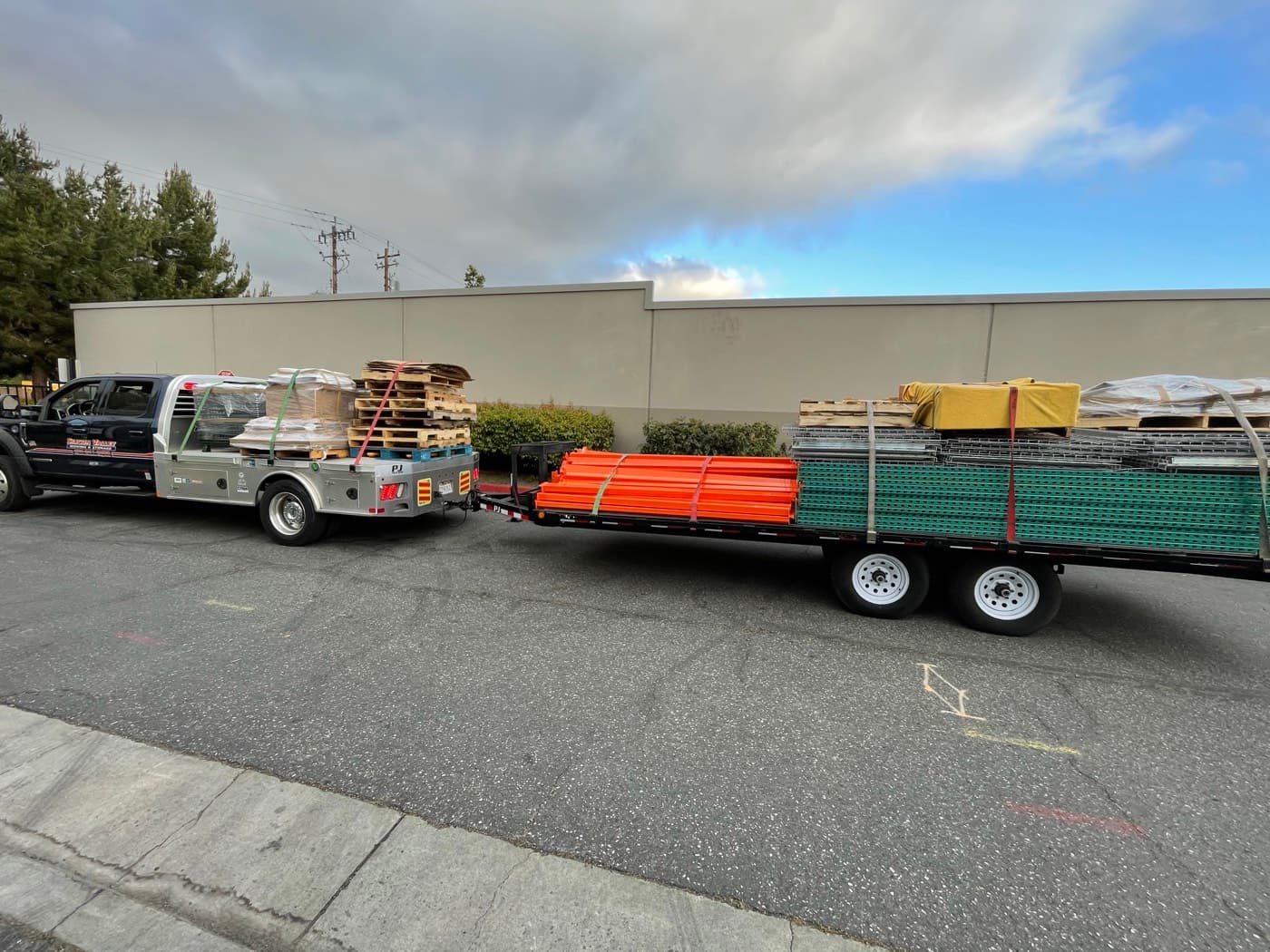 Silicon Valley Moving flatbed staged with warehouse racking — Bay Area pallet storage and distribution