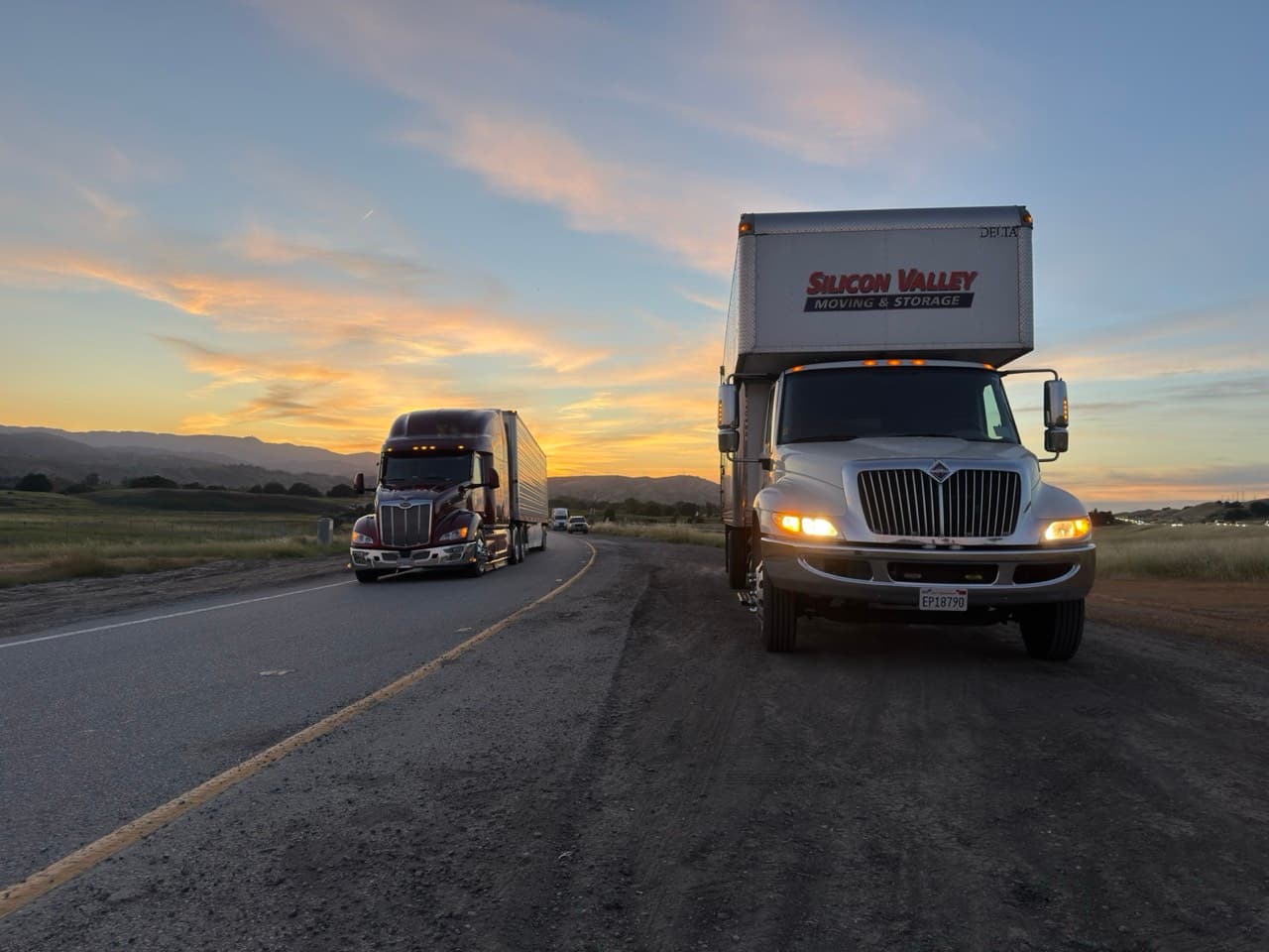 SVM truck and Bekins semi-trailer on the highway at sunset during an interstate move