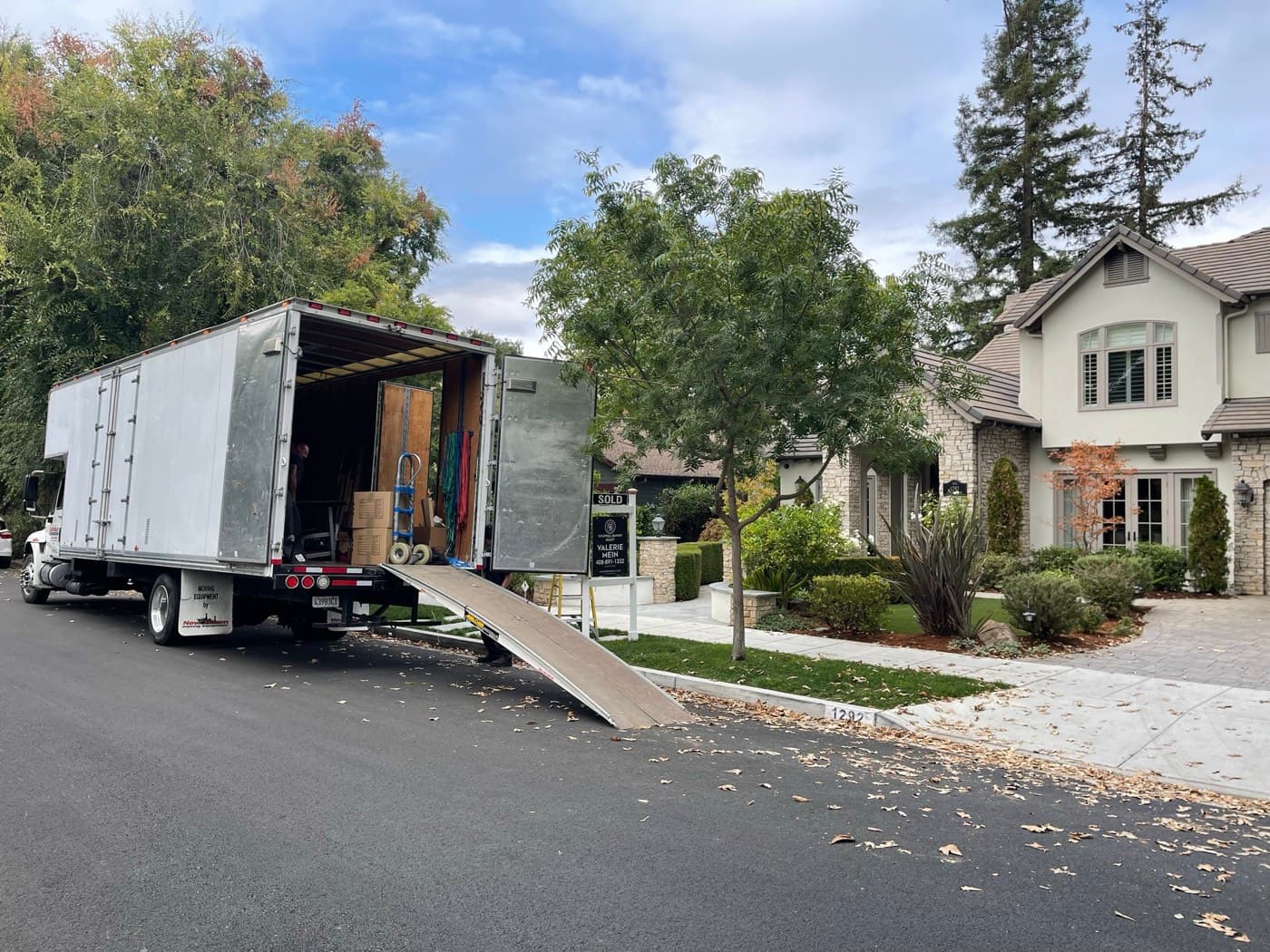 Silicon Valley Moving truck with deployed loading ramp at a Bay Area commercial property — business and FF&E storage