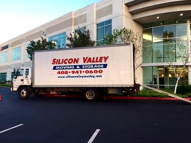 Silicon Valley Moving box truck loaded at the entrance of a San Jose office building during an evening office move